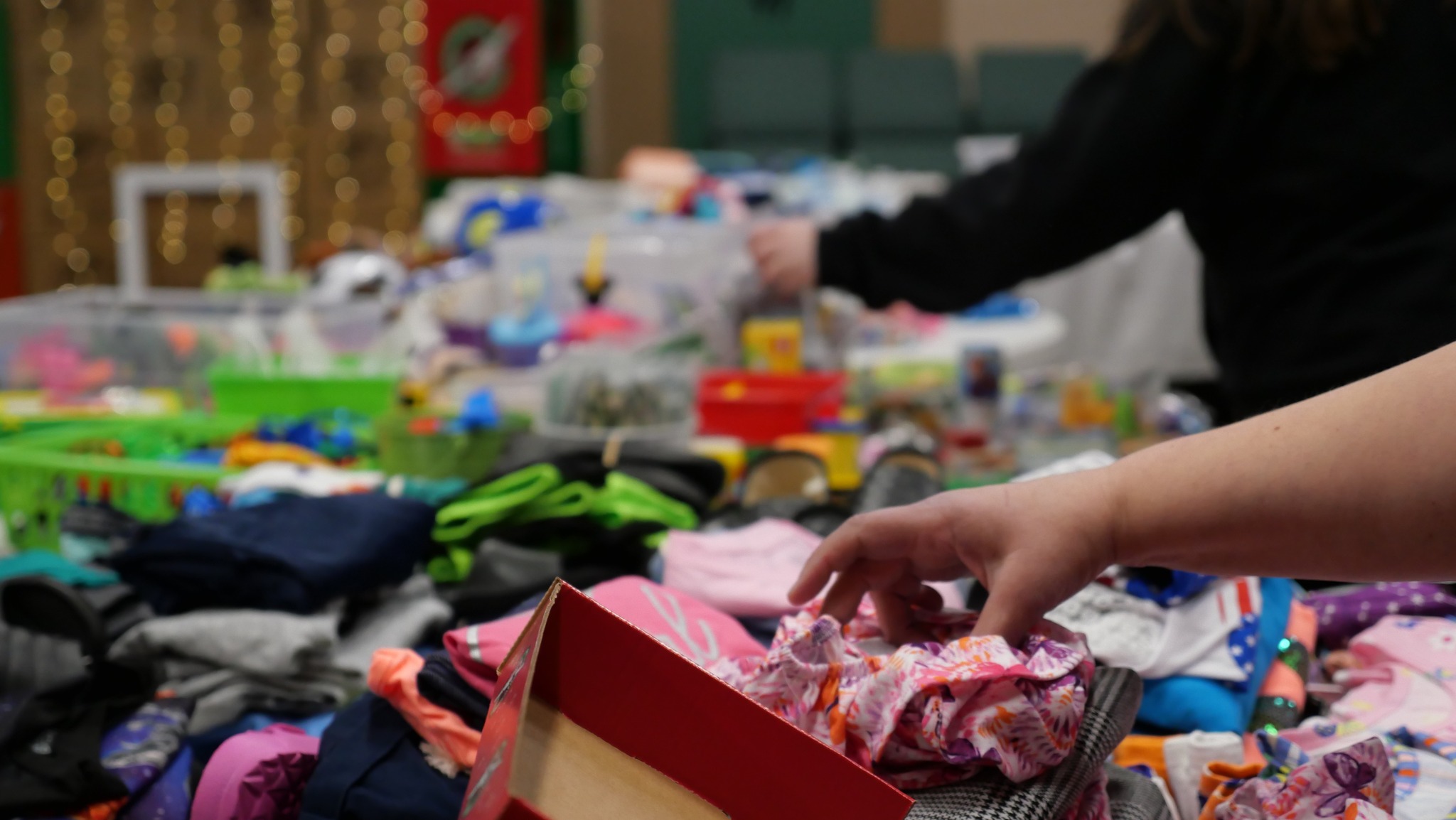 Sorting clothing and practical care items for neighbors